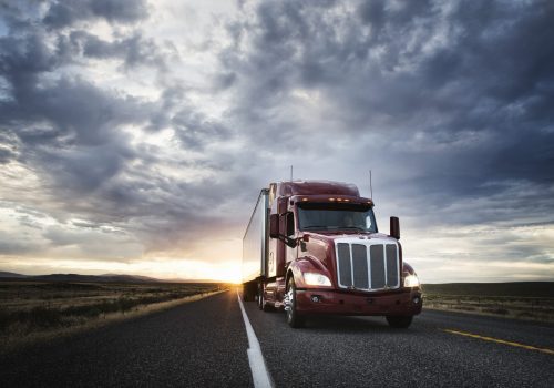 3/4 front view of a  commercial truck on the road at sunset  in eastern Washington, USA